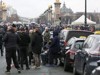 Taxi drivers gather at the Invalides during a protest against lower mileage rates for medical patient transport in Paris, France, on Decembe...