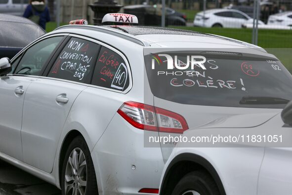 Taxi drivers gather at the Invalides in Paris, France, on December 3, 2024, during a demonstration against a new downward pricing system for...