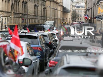 Taxi drivers gather at the Invalides, in front of the Assemblee nationale, during a protest against lower mileage rates for medical patient...