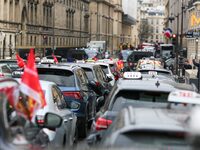 Taxi drivers gather at the Invalides, in front of the Assemblee nationale, during a protest against lower mileage rates for medical patient...