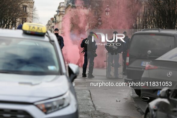 Taxi drivers wave smoke bombs at the Invalides during a protest against lower mileage rates for patient transport in Paris, France, on Decem...