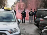 Taxi drivers wave smoke bombs at the Invalides during a protest against lower mileage rates for patient transport in Paris, France, on Decem...