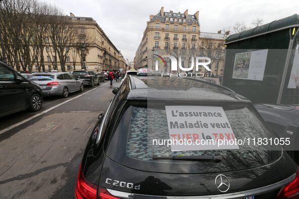 Taxi drivers gather at the Invalides, in front of the Assemblee nationale, during a protest against lower mileage rates for medical patient...