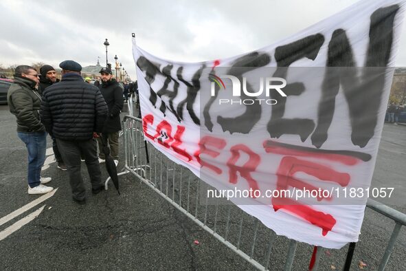 Taxi drivers display a banner reading ''taxi drivers in anger'' at the Invalides during a protest against lower mileage rates for patient tr...