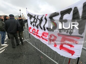 Taxi drivers display a banner reading ''taxi drivers in anger'' at the Invalides during a protest against lower mileage rates for patient tr...