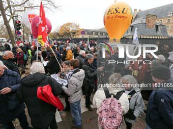 Retirees participate in a rally to call for pensions to be raised with inflation in Paris, France, on December 3, 2024, near the Prime Minis...