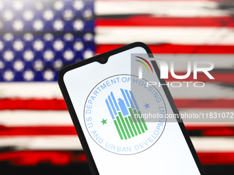 The United States Department of Housing and Urban Development (HUD) logo appears on the screen of a smartphone, and in the background, the f...