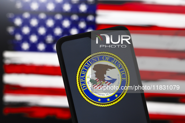 The United States Department of Justice (DOJ) logo appears on the screen of a smartphone, and in the background, the flag of the United Stat...