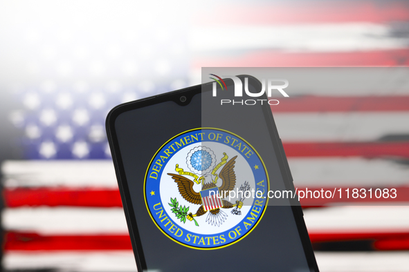 The United States Department of State (DOS) logo appears on the screen of a smartphone, and in the background, the flag of the United States...