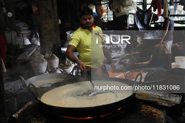 Workers prepare ''Laddu,'' a ball-shaped sweet, inside a workshop for sale in the wholesale market in Jayanagar village on the outskirts of...