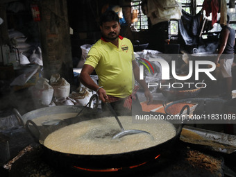 Workers prepare ''Laddu,'' a ball-shaped sweet, inside a workshop for sale in the wholesale market in Jayanagar village on the outskirts of...