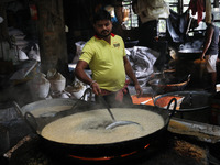 Workers prepare ''Laddu,'' a ball-shaped sweet, inside a workshop for sale in the wholesale market in Jayanagar village on the outskirts of...