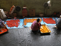 Workers prepare ''Laddu,'' a ball-shaped sweet, inside a workshop for sale in the wholesale market in Jayanagar village on the outskirts of...