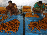 Workers prepare ''Laddu,'' a ball-shaped sweet, inside a workshop for sale in the wholesale market in Jayanagar village on the outskirts of...