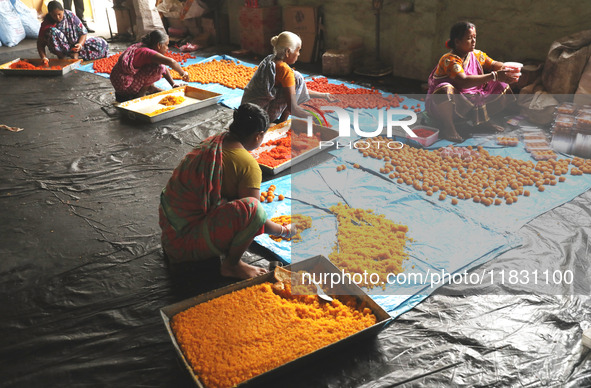 Workers prepare ''Laddu,'' a ball-shaped sweet, inside a workshop for sale in the wholesale market in Jayanagar village on the outskirts of...