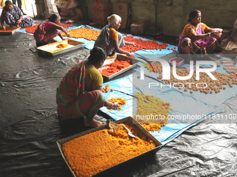 Workers prepare ''Laddu,'' a ball-shaped sweet, inside a workshop for sale in the wholesale market in Jayanagar village on the outskirts of...