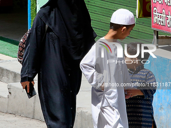 A Muslim woman and her two children walk along a street in Mussoorie, Uttarakhand, India, on April 18, 2024. (