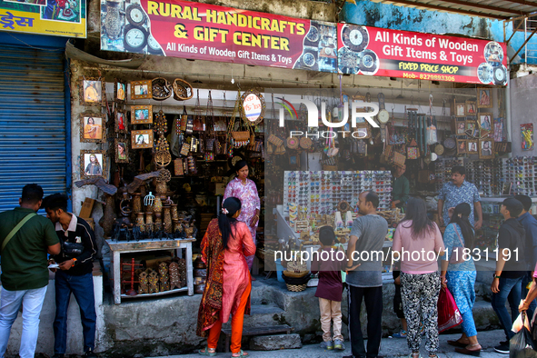 Indian tourists buy local handicraft items at a shop in Mussoorie, Uttarakhand, India, on April 18, 2024. 