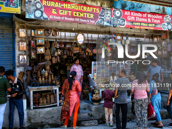 Indian tourists buy local handicraft items at a shop in Mussoorie, Uttarakhand, India, on April 18, 2024. (