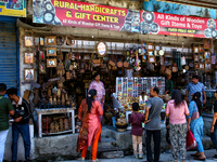 Indian tourists buy local handicraft items at a shop in Mussoorie, Uttarakhand, India, on April 18, 2024. (