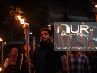 Bangladeshi activists of the Democratic Students Alliance stage a protest rally and torch procession against the attack on the Bangladesh As...