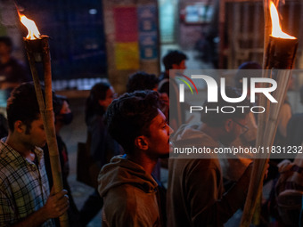 Bangladeshi activists of the Democratic Students Alliance stage a protest rally and torch procession against the attack on the Bangladesh As...