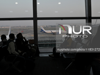 Passengers wait for their flights at the Netaji Subhash Chandra Bose International Airport in Kolkata, India, on December 3, 2024. (