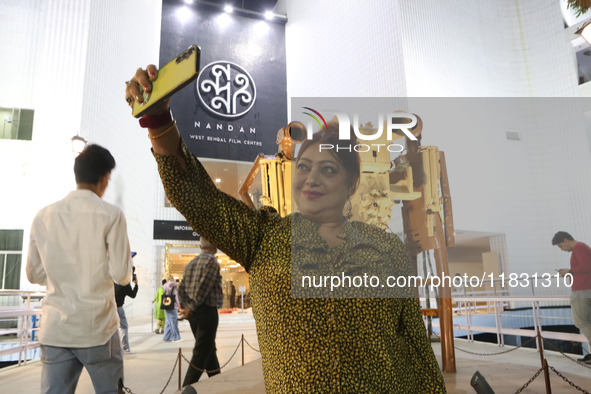 A woman takes a selfie with her mobile in front of Nandan Film Center, one of the venues of the 30th Kolkata International Film Festival in...