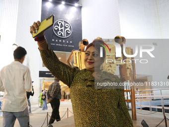 A woman takes a selfie with her mobile in front of Nandan Film Center, one of the venues of the 30th Kolkata International Film Festival in...