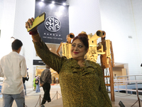 A woman takes a selfie with her mobile in front of Nandan Film Center, one of the venues of the 30th Kolkata International Film Festival in...