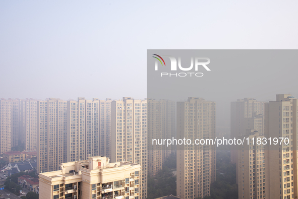 Buildings loom in the morning fog in Ningbo, Zhejiang province, China, on December 3, 2024. 