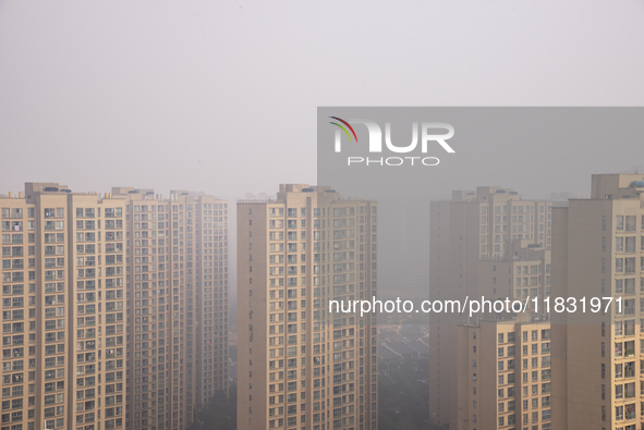 Buildings loom in the morning fog in Ningbo, Zhejiang province, China, on December 3, 2024. 