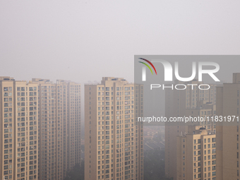 Buildings loom in the morning fog in Ningbo, Zhejiang province, China, on December 3, 2024. (