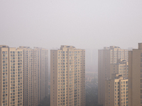 Buildings loom in the morning fog in Ningbo, Zhejiang province, China, on December 3, 2024. (