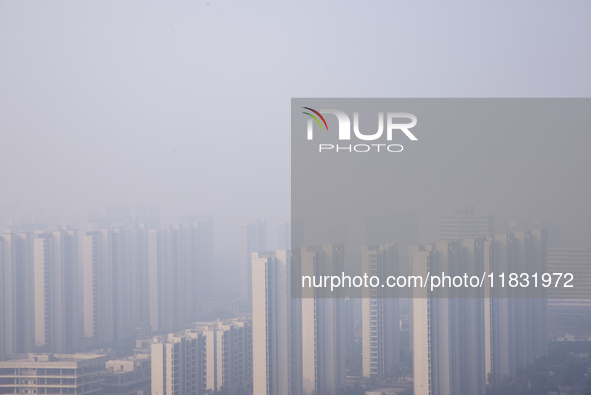 Buildings loom in the morning fog in Ningbo, Zhejiang province, China, on December 3, 2024. 