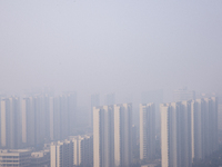 Buildings loom in the morning fog in Ningbo, Zhejiang province, China, on December 3, 2024. (