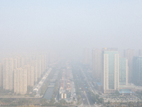 Buildings loom in the morning fog in Ningbo, Zhejiang province, China, on December 3, 2024. (