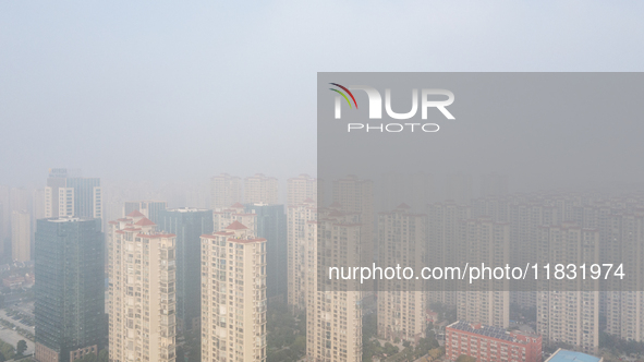 Buildings loom in the morning fog in Ningbo, Zhejiang province, China, on December 3, 2024. 