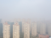 Buildings loom in the morning fog in Ningbo, Zhejiang province, China, on December 3, 2024. (