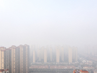 Buildings loom in the morning fog in Ningbo, Zhejiang province, China, on December 3, 2024. (