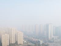 Buildings loom in the morning fog in Ningbo, Zhejiang province, China, on December 3, 2024. (