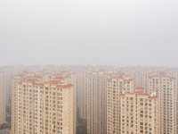 Buildings loom in the morning fog in Ningbo, Zhejiang province, China, on December 3, 2024. (