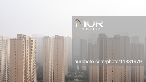 Buildings loom in the morning fog in Ningbo, Zhejiang province, China, on December 3, 2024. 