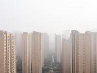 Buildings loom in the morning fog in Ningbo, Zhejiang province, China, on December 3, 2024. (