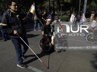 On December 3, 2024, in Mexico City, Mexico, dozens of people with disabilities and wheelchair users demonstrate on the occasion of the Inte...