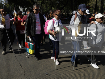 People with disabilities demonstrate on the occasion of the International Day of Persons with Disabilities, marching on Avenida Juarez to th...