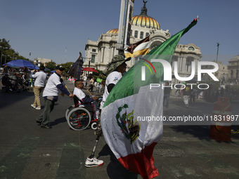 People with disabilities demonstrate on the occasion of the International Day of Persons with Disabilities, marching on Avenida Juarez to th...