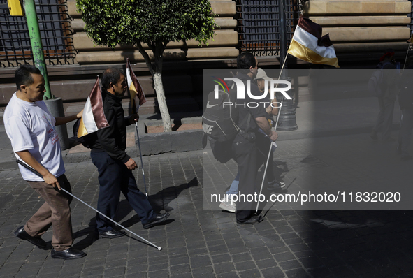 People with disabilities demonstrate on the occasion of the International Day of Persons with Disabilities, marching on Avenida Juarez to th...