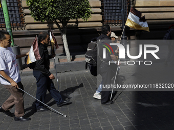 People with disabilities demonstrate on the occasion of the International Day of Persons with Disabilities, marching on Avenida Juarez to th...