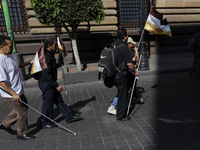 People with disabilities demonstrate on the occasion of the International Day of Persons with Disabilities, marching on Avenida Juarez to th...